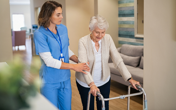nurse helping old woman