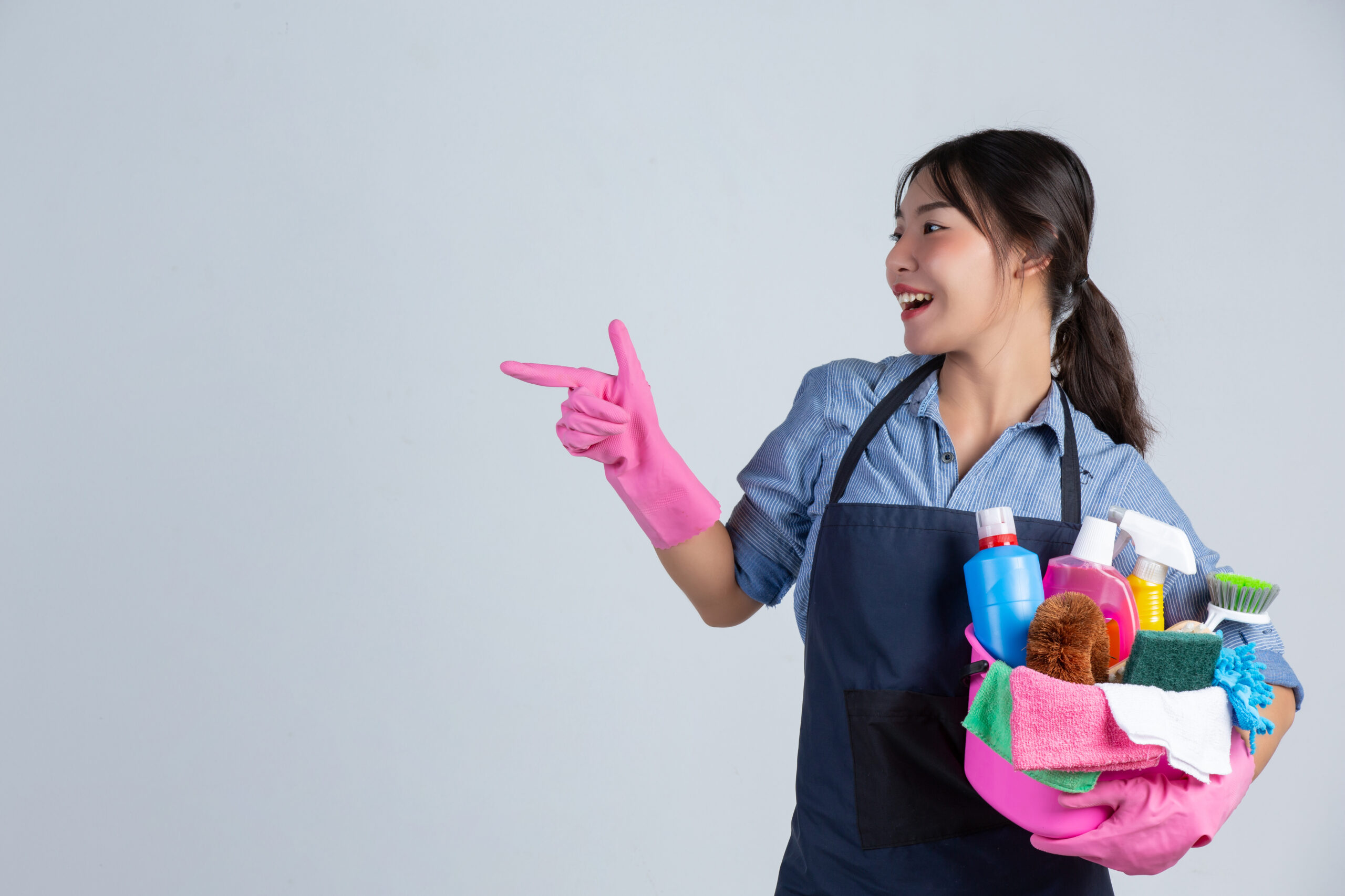 Professional housekeeper cleaning a modern family home, promoting hygiene and comfort for children and elderly family members.
