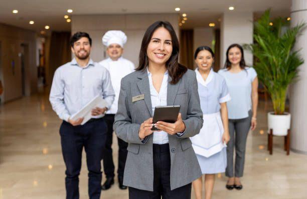 Professional household staff team standing together in a luxury setting.