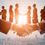 Business professionals shaking hands during a corporate meeting.