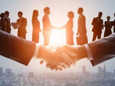 Business professionals shaking hands during a corporate meeting.