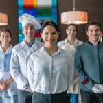 Professional hospitality and household staff team standing together in a luxury setting.