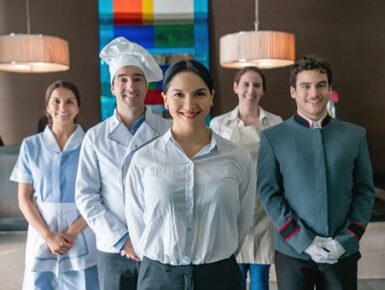 Professional hospitality and household staff team standing together in a luxury setting.