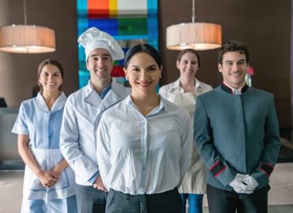 Professional hospitality and household staff team standing together in a luxury setting.