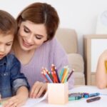Professional nanny helping children with creative learning activities at home in Mumbai.