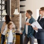 Professional household staffing consultant discussing home staffing requirements with a family.